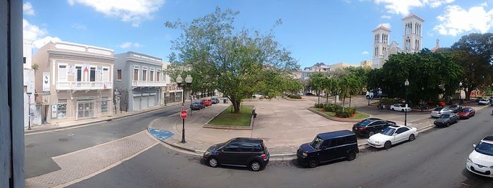 Cars on road in city against sky