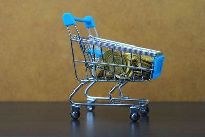 Stacked coins in toy shopping cart