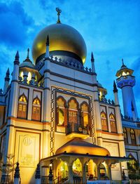 Low angle view of illuminated building against sky