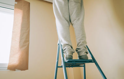 Low section of man standing on staircase