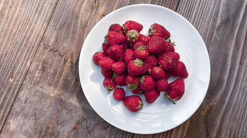 High angle view of strawberries in plate on table