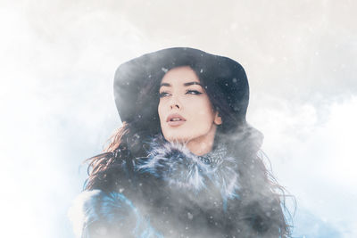 Close-up of smiling young woman in snow