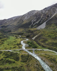 Scenic view of a river stream against the backdrop of mountains 