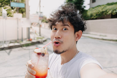 Portrait of man drinking cocktail