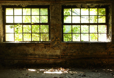 Abandoned building seen through glass window