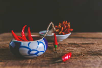 Close-up of red chili peppers on table