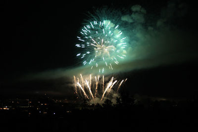 Low angle view of firework display at night