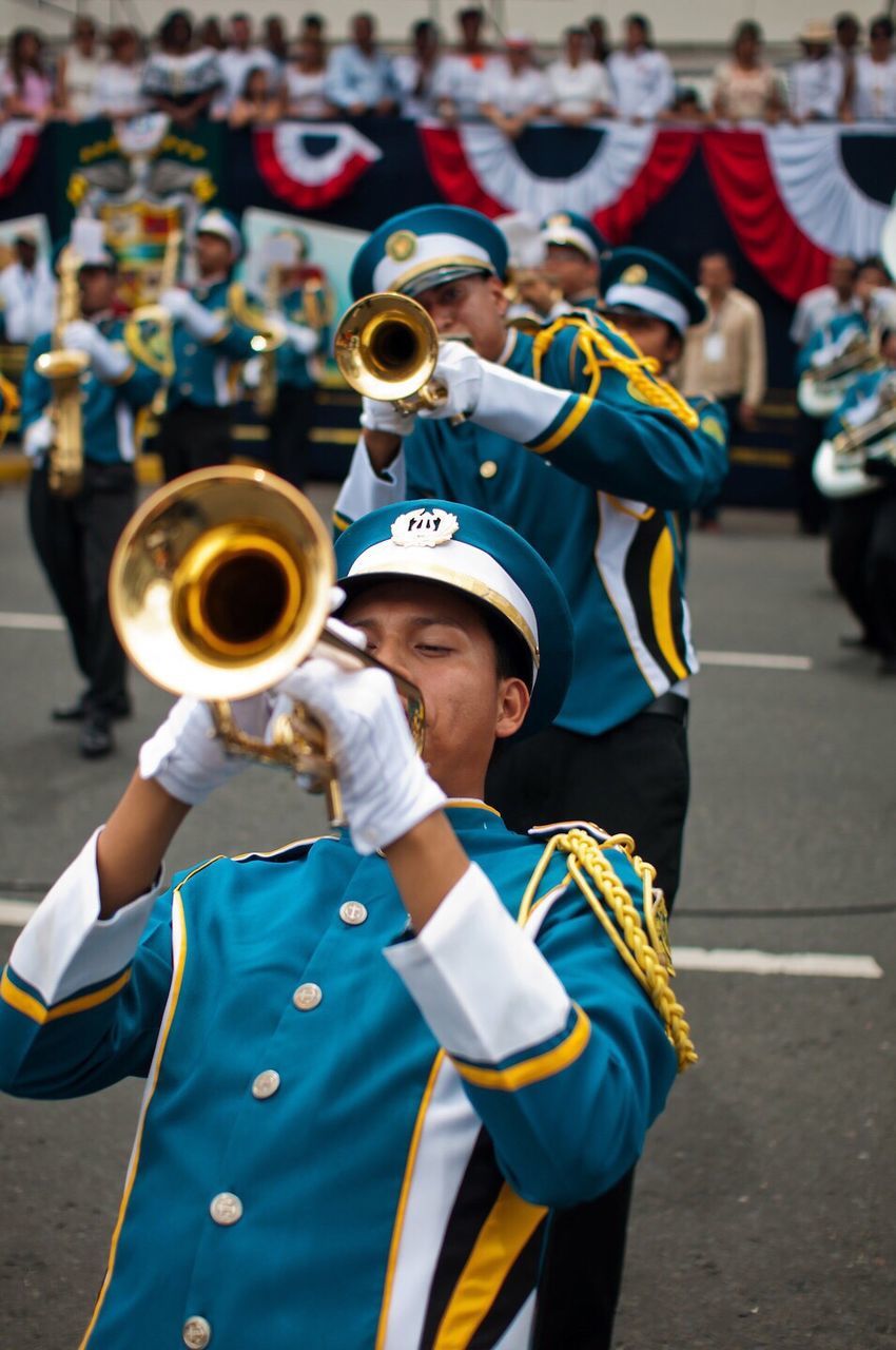 music, outdoors, musical instrument, trumpet, day, parade, people, uniform, adult, performance, musician