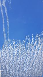 Close-up of airplane wing against sky during winter