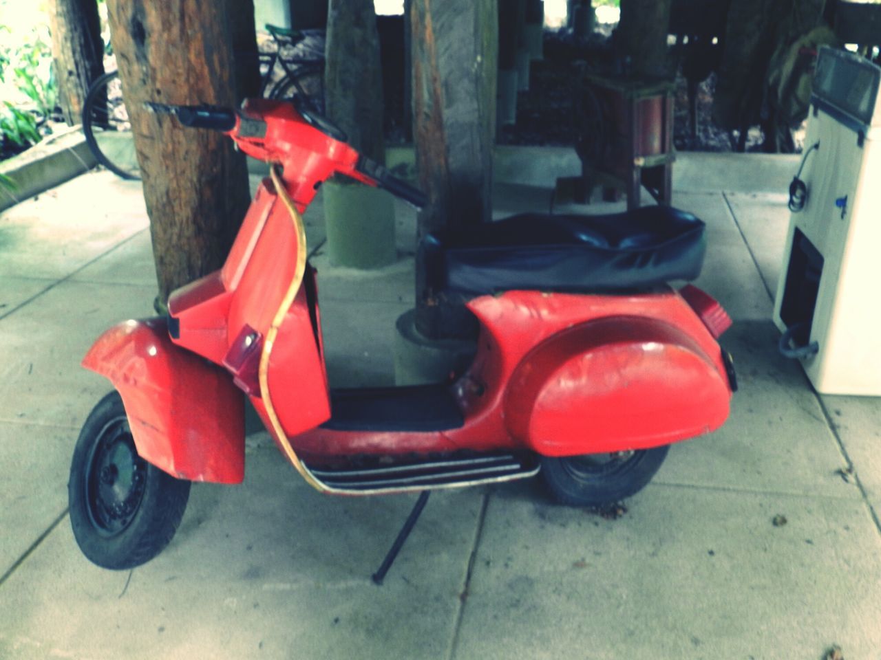 land vehicle, red, transportation, mode of transport, stationary, car, parking, street, parked, absence, chair, seat, day, no people, outdoors, built structure, building exterior, sidewalk, parking lot, bicycle