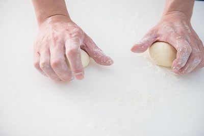 Cropped image of hand holding over white background