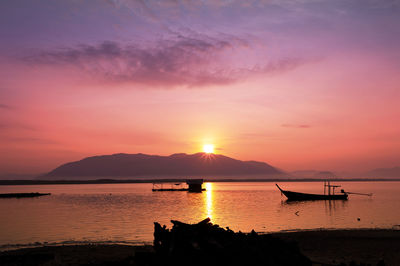 Scenic view of sea against romantic sky at sunset