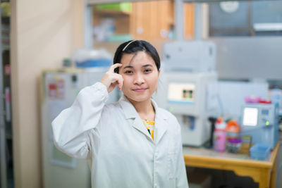 Confident nurse working at laboratory