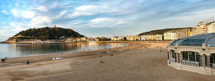 Panoramic view of sea and buildings against sky