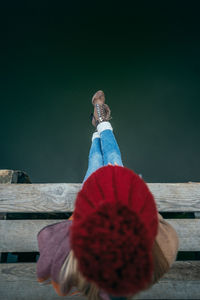 Directly above shot of woman sitting on pier over sea