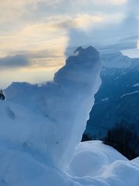 Scenic view of snow covered mountains against sky during sunset