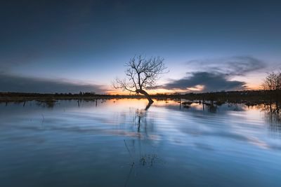 Scenic view of lake against sky during sunset