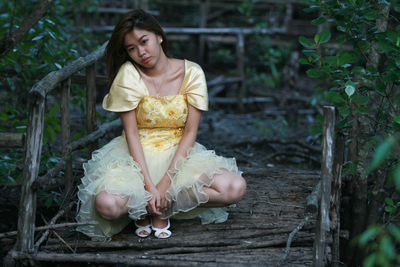 Young woman posing in dress outdoors