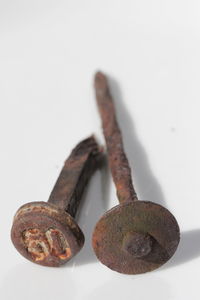 Close-up of rusty metal against white background