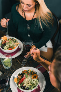 Midsection of woman holding food in restaurant