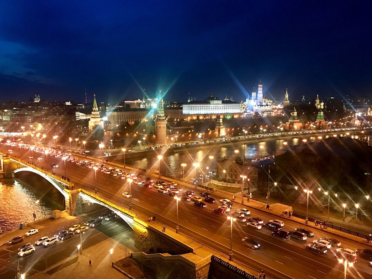 illuminated, night, architecture, city, transportation, street, built structure, road, building exterior, sky, motor vehicle, traffic, long exposure, car, motion, light trail, high angle view, mode of transportation, no people, nature, cityscape, outdoors, multiple lane highway