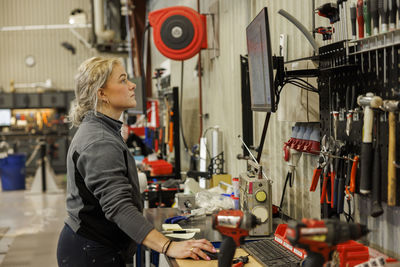 Young female industrial worker working in factory