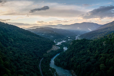 High angle view of river amidst mountains against sky