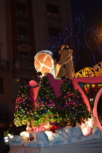 Low angle view of christmas tree at night