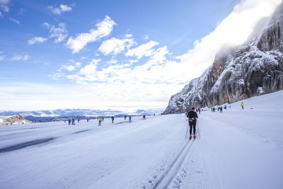 Group of people skiing on snow landscape