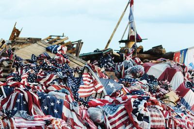 Heap of american flags on wooden pallets during memorial event