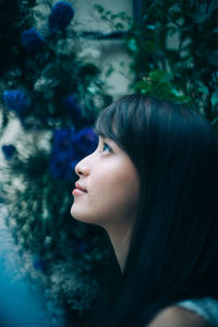 Close-up portrait of a young woman looking away