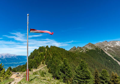 Low angle view of flag against blue sky