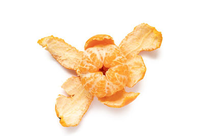 High angle view of orange leaf on white background