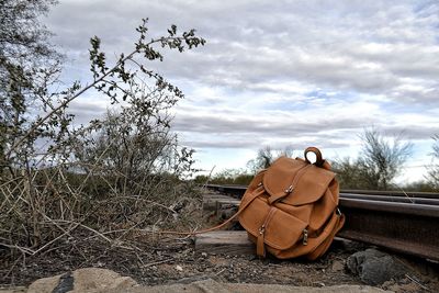Abandoned car on field against sky