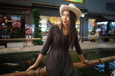 Woman looking away while standing in shopping mall