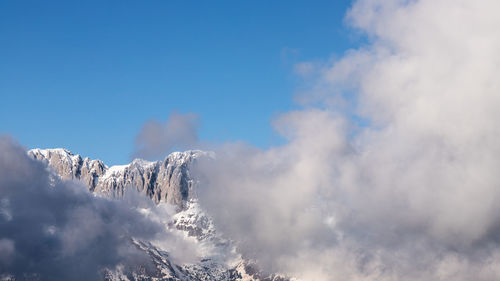 Low angle view of snowcapped mountain against sky