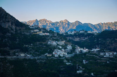 View of cityscape and mountain against sky