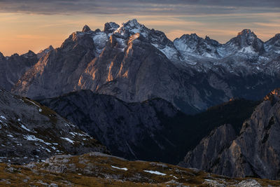 Scenic view of snowcapped mountains against sky during sunset