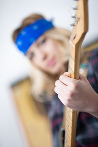 Low angle view of woman holding guitar