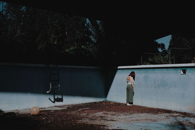 Woman photographing umbrella at night