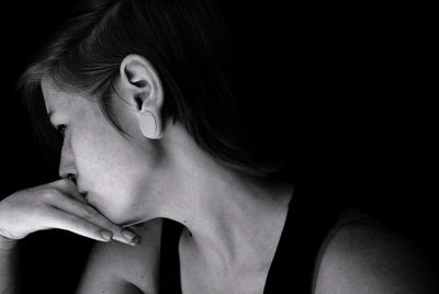 Close-up of fashion model against black background