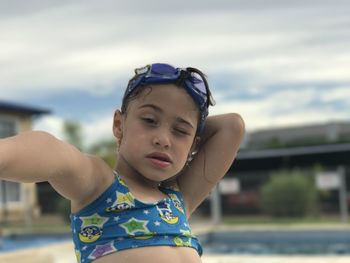 Cute girl wearing swimwear on poolside