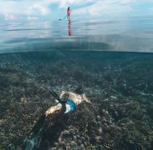 Young couple have a fun in ocean, underwater view