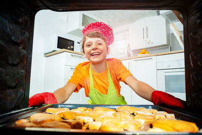 Portrait of smiling young woman holding food