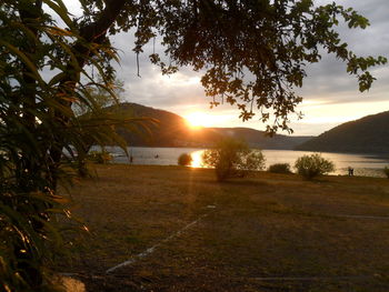 Scenic view of lake against sky during sunset