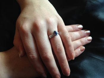 Midsection of woman wearing diamond ring