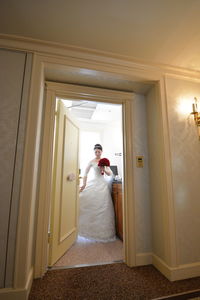Man standing on door at home