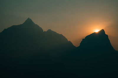 Scenic view of silhouette mountain against sky during sunset