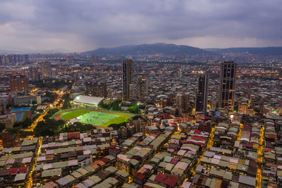 High angle view of illuminated buildings against sky in city