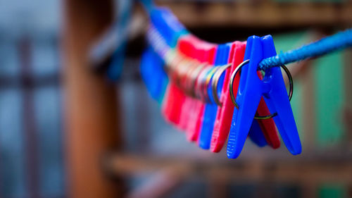 Close-up of clothespins hanging on rope